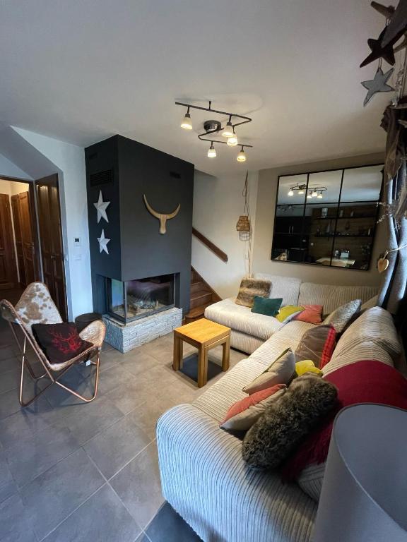un salon avec deux canapés et une cheminée dans l'établissement Chalet Seven - 8 pers - proche centre, aux Gets