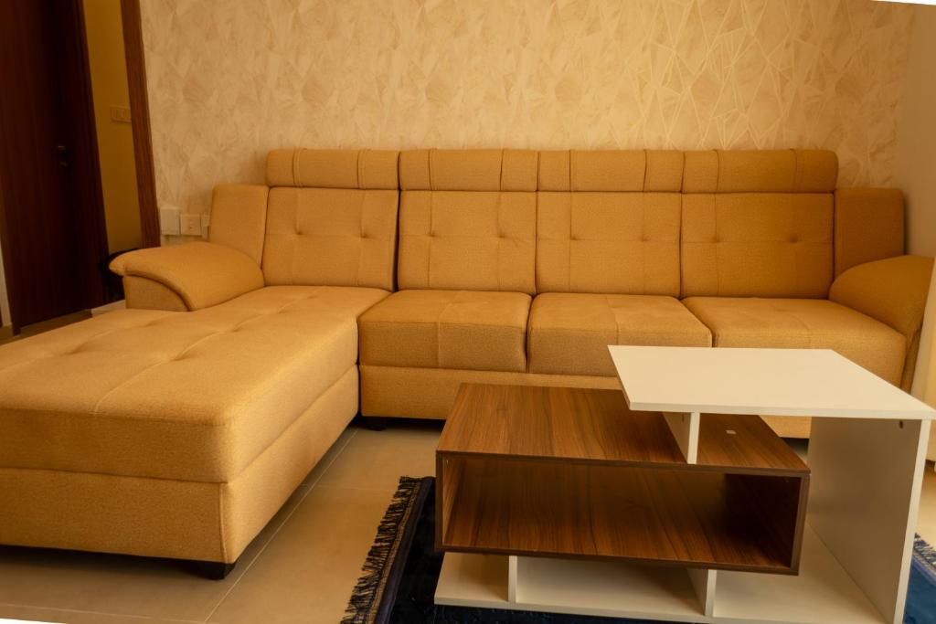 a living room with a couch and a coffee table at Elegance Retreat in Yelahanka