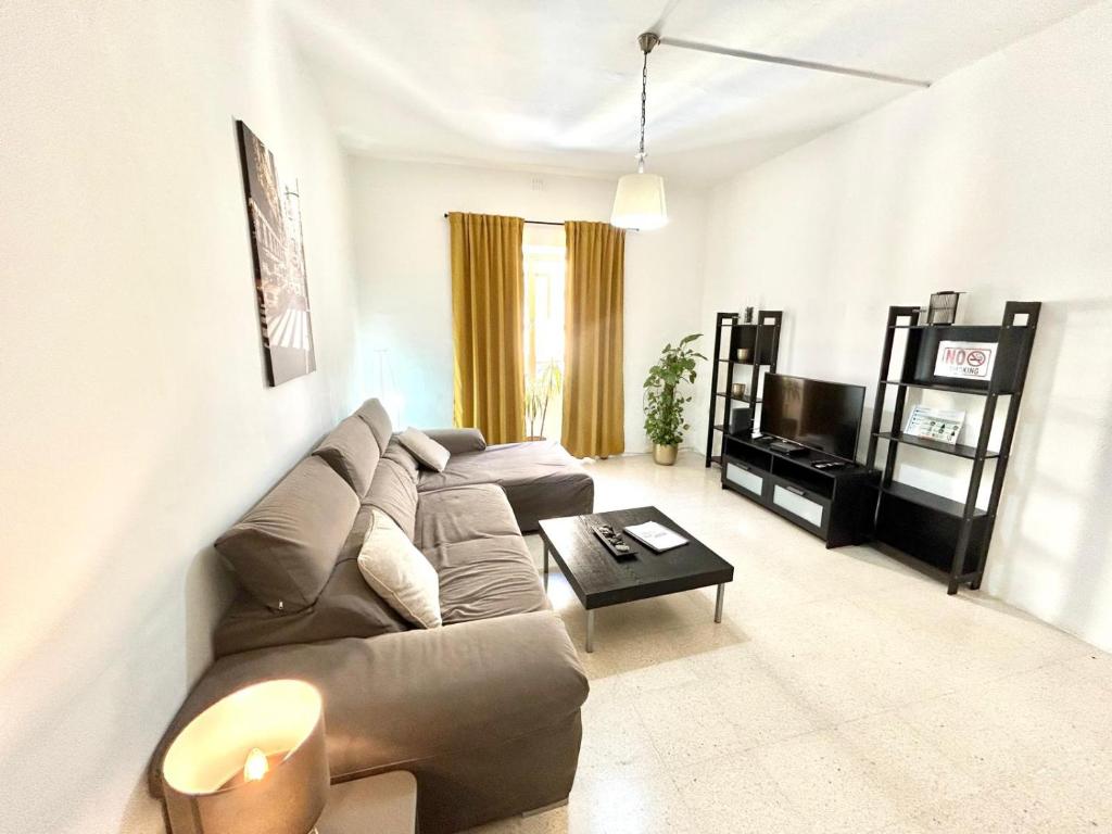 a living room with a couch and a table at St Julians - Balluta Bay large 3 bedroom apartment in Sliema
