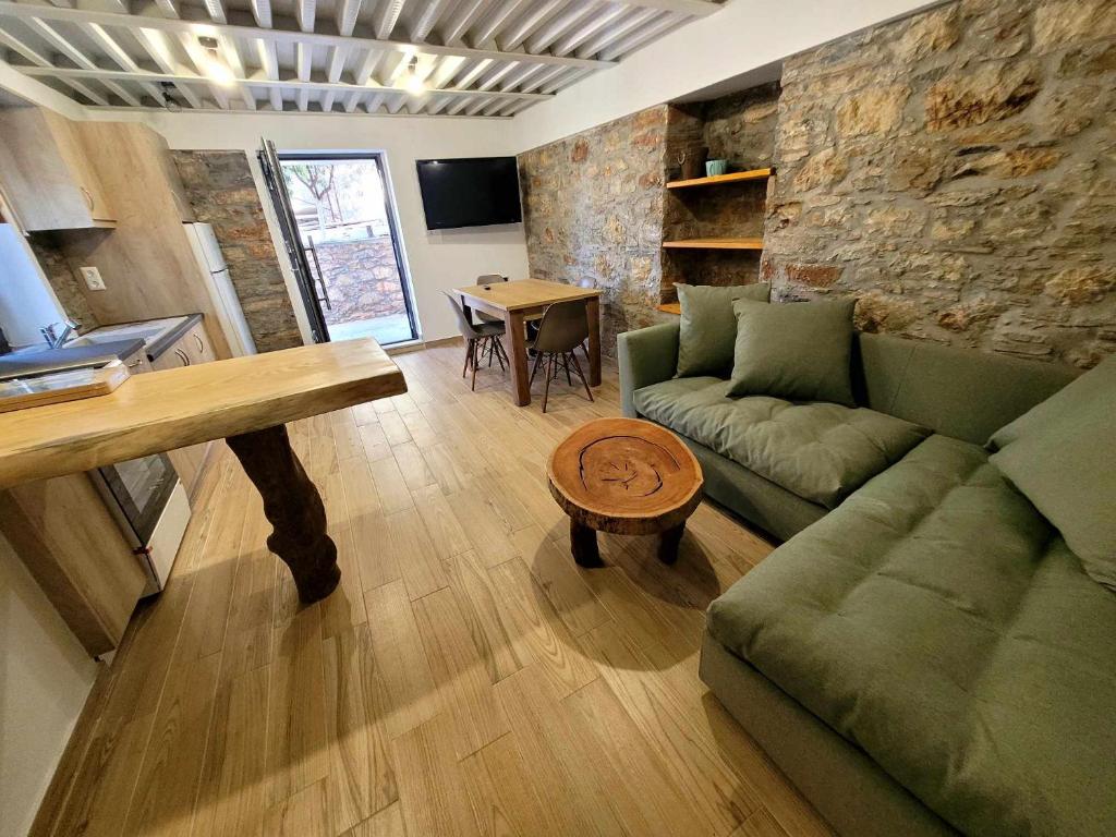a living room with a couch and a table at Danai Traditional Apartment in Samos