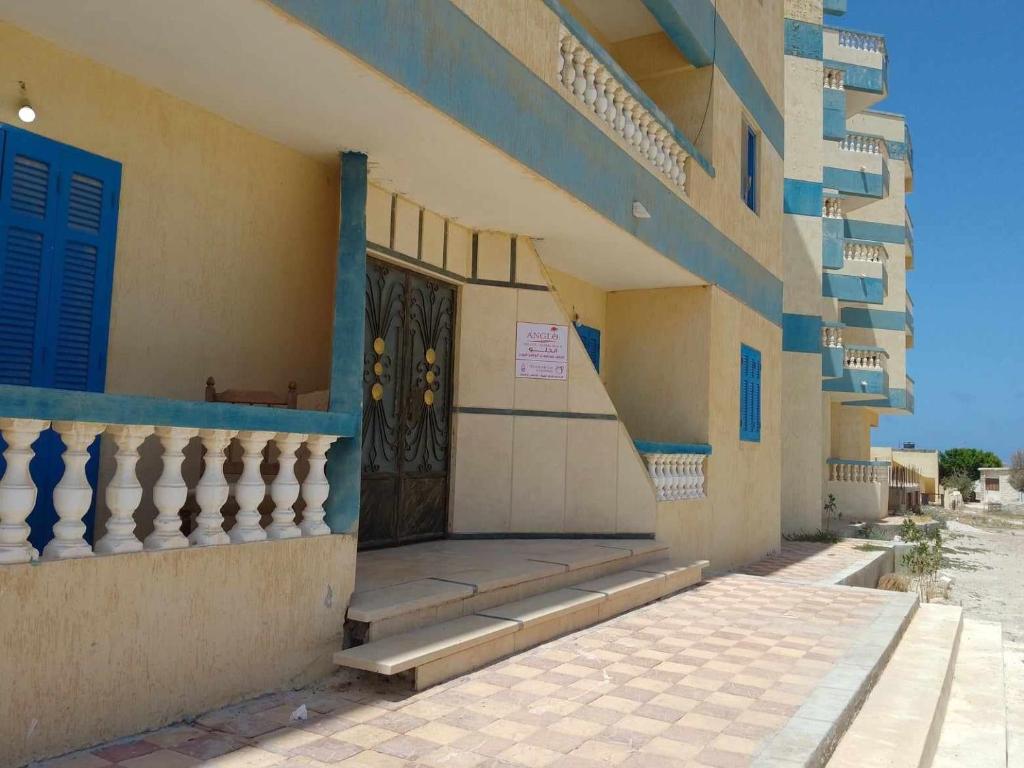 a building with a door and steps in front at Anglo Chalets - Ageeba beach in Marsa Matruh