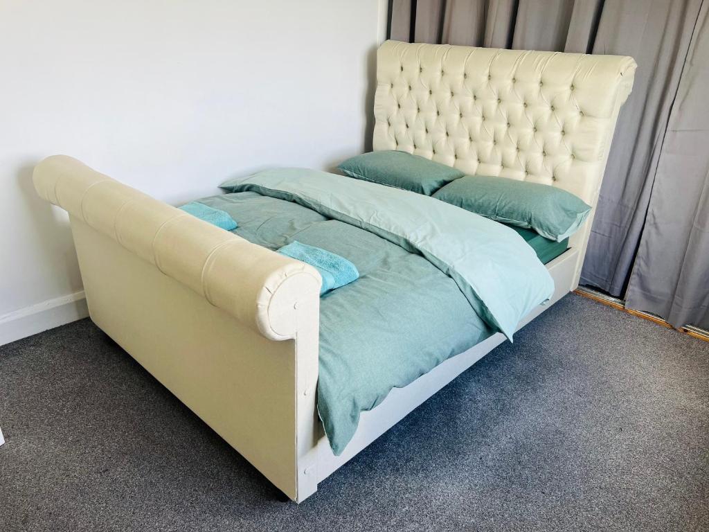 a bed with blue pillows on it in a bedroom at One Bedroom Flat/Apartment. in Bexleyheath