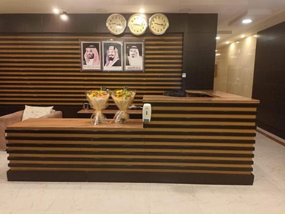 a counter in a store with clocks on the wall at مهاد للشقق المخدومه in Najran