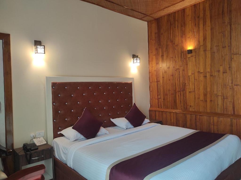 a bedroom with a large bed in a room at Hotel Tawang in Tawang