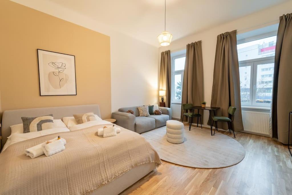 a bedroom with a large bed and a couch at Delia Apartment I levestate in Vienna