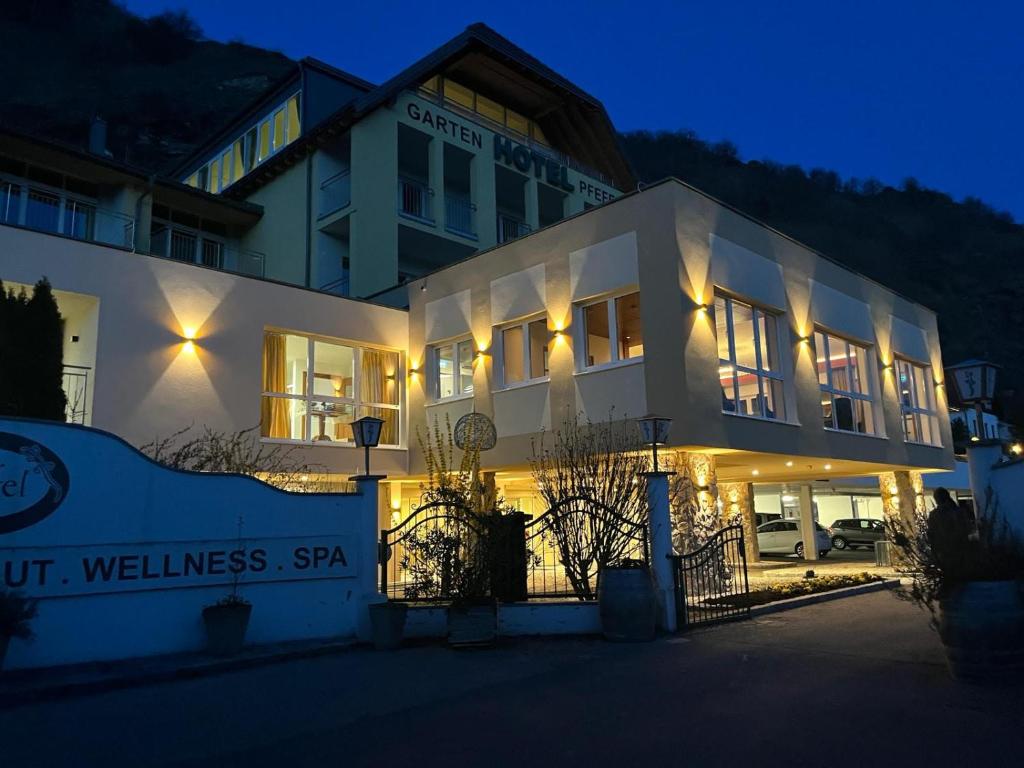 a building with lights in front of it at night at Gartenhotel & Weingut Pfeffel Dürnstein in Dürnstein