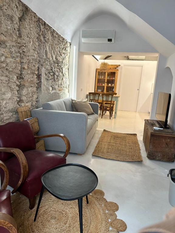 a living room with a couch and chairs and a table at Brava Apartaments casa centro Begur in Begur