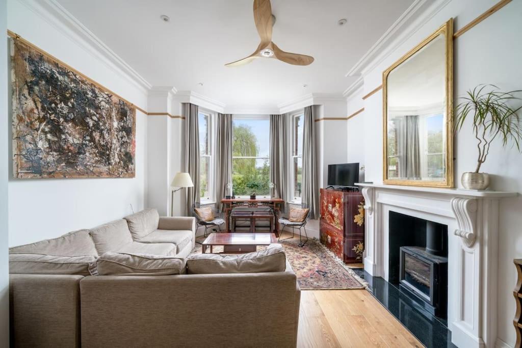 a living room with a couch and a fireplace at Stunning house near Notting Hill in London