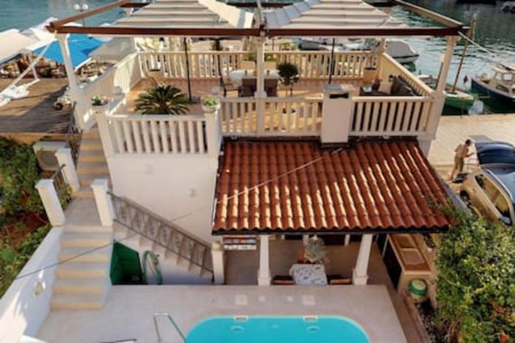 an aerial view of a house with a swimming pool at Radovani Luxury Apartment with Private Pool in Jelsa