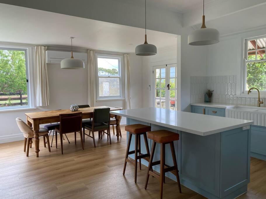 a kitchen with a table and some chairs and a table and a counter at McIntyre homestead in Penshurst