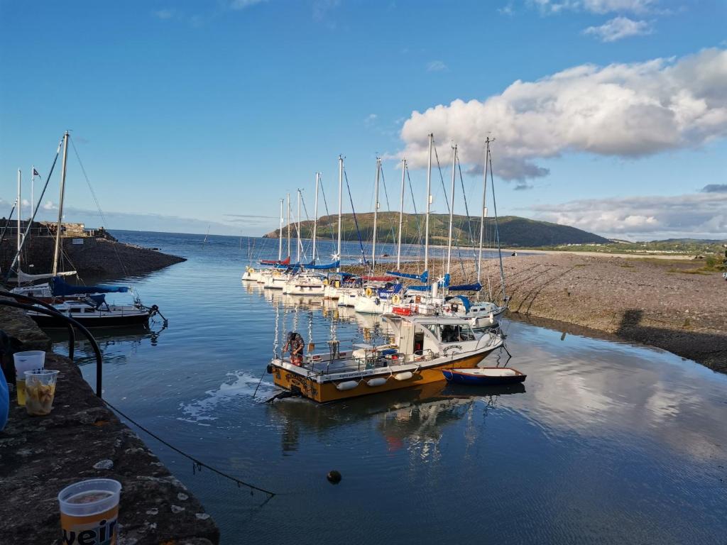 a group of boats docked in a body of water at Harbour House Studio, Porlock Weir in Culbone
