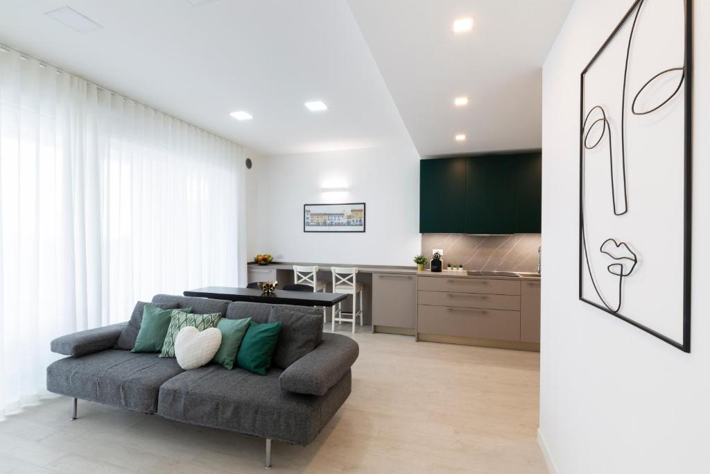 a living room with a couch and a kitchen at Terminal Tower 601 - San Cristoforo M4 in Milan