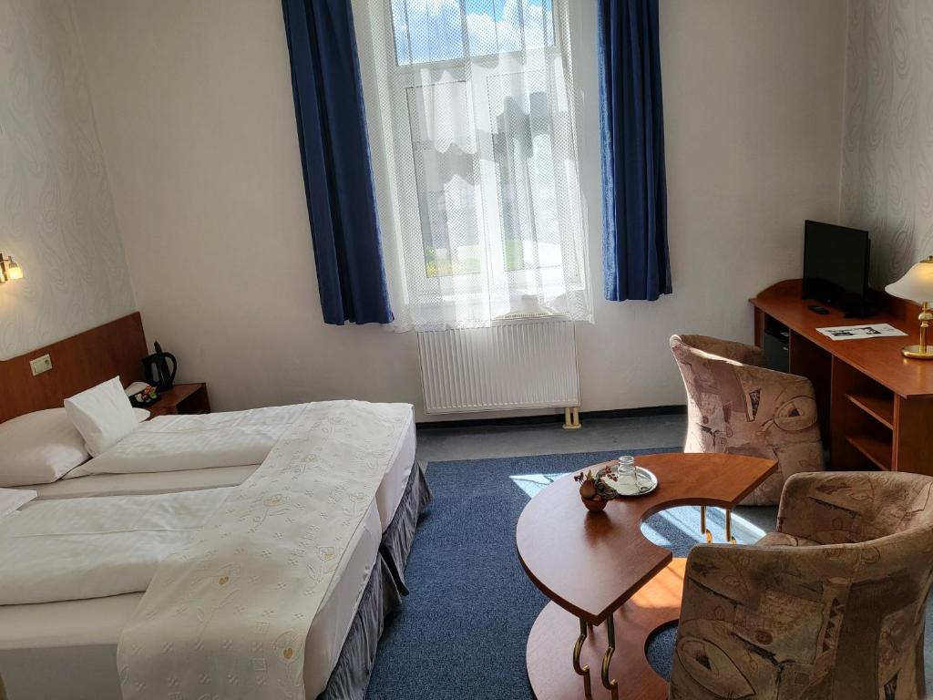 Postel nebo postele na pokoji v ubytování Hotel Margit