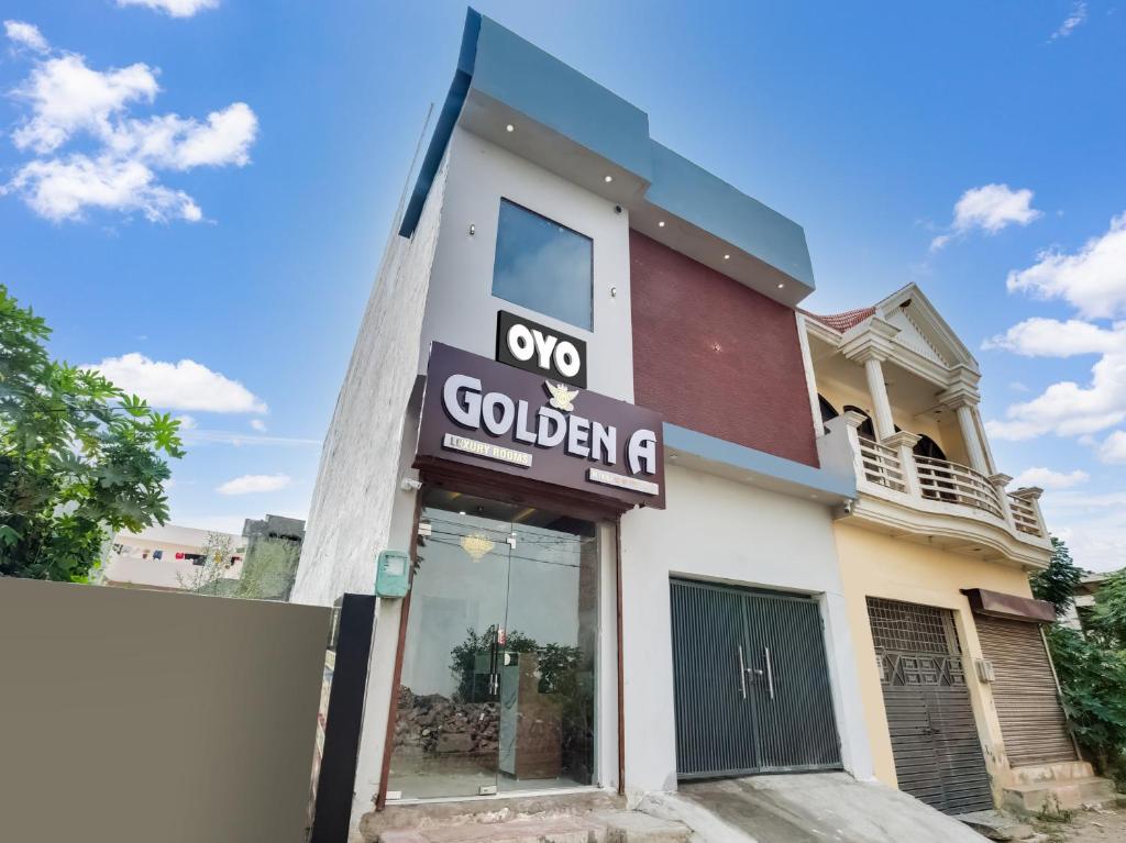 a building with a sign for a golden g at OYO Flagship Golden A in Ludhiana