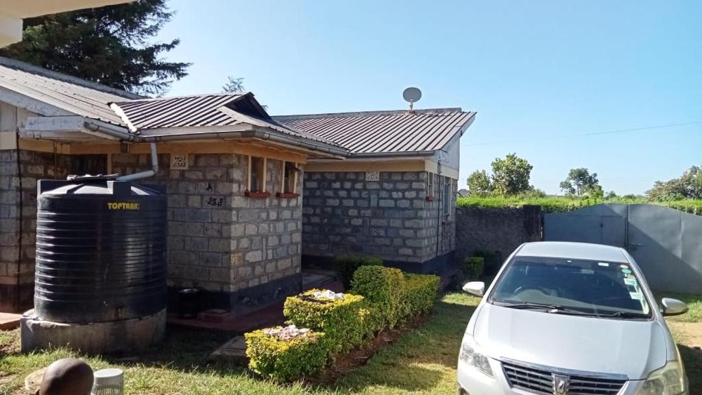 a white car parked in front of a house at FAVOURED EVAMAX in Eldoret