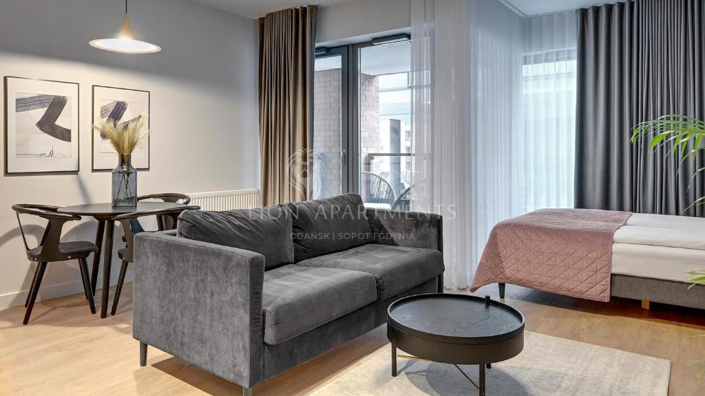 a living room with a couch and a bed at Lion Apartments - City Center Scala Apartments&Studio IIIA in Gdańsk