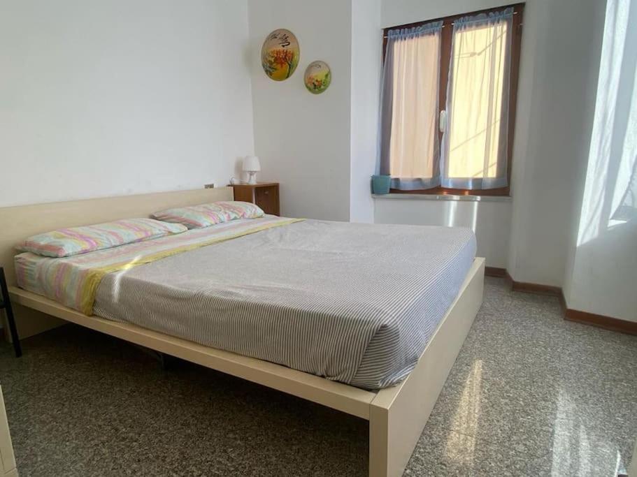 a bedroom with a bed in a room with a window at La casa di Raffa in Bonassola