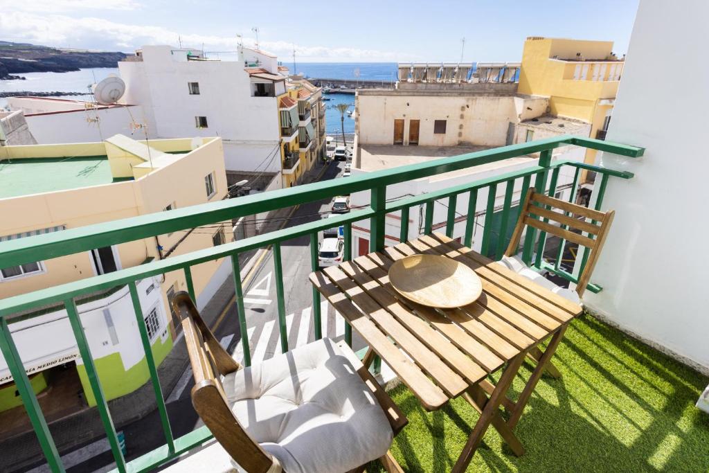 a table and chairs on a balcony with a view at Nice 2 bd apartment by the sea in Playa San Juan in Playa de San Juan