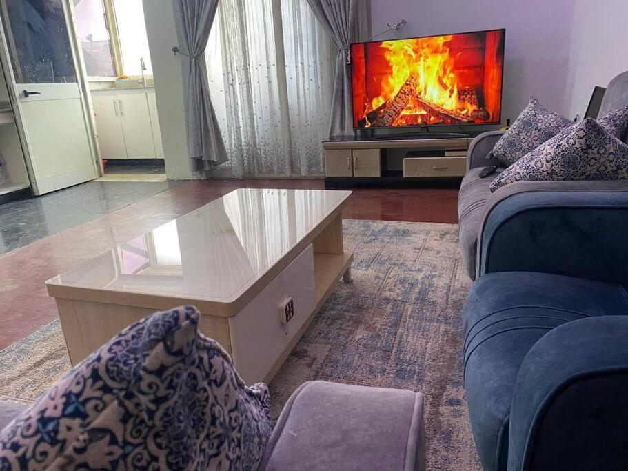 a living room with a couch and a coffee table at Stylish & Convenient Condo for couples and familes in Addis Ababa
