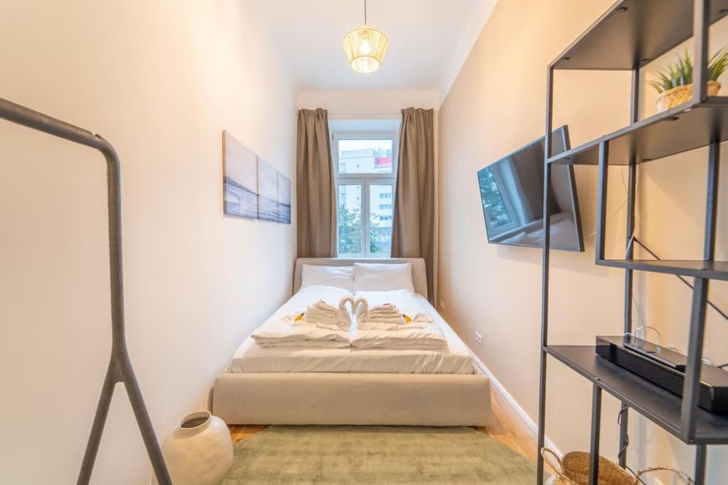 a small bedroom with a bed and a window at Dorothea Apartment I levestate in Vienna
