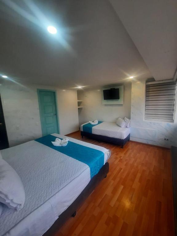 Postel nebo postele na pokoji v ubytování Hotel Zafiro Boutique