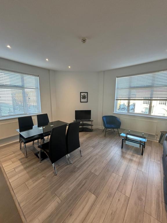 a room with a table and chairs and two windows at Access Euston in London