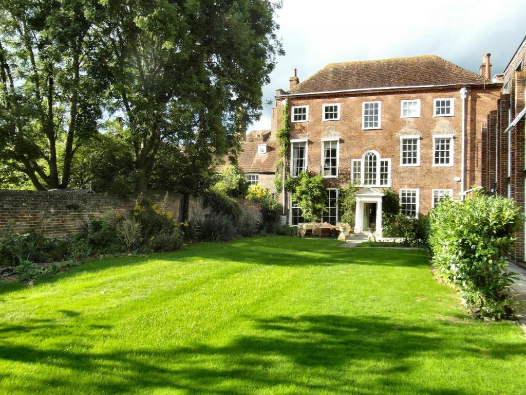 a large lawn in front of a house at Large 8 Bedroom Georgian House in Central Chichester with Parking - Great for Celebrations! in Chichester