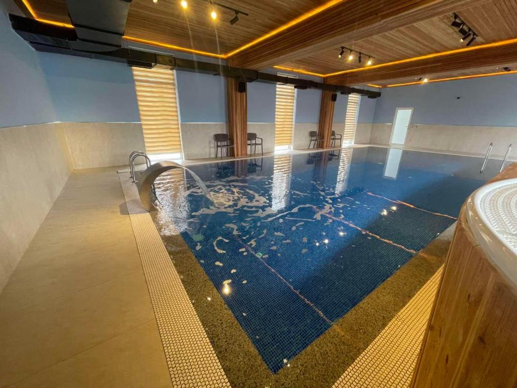 a large swimming pool in the middle of a building at Hotel Konstantin in Pristina