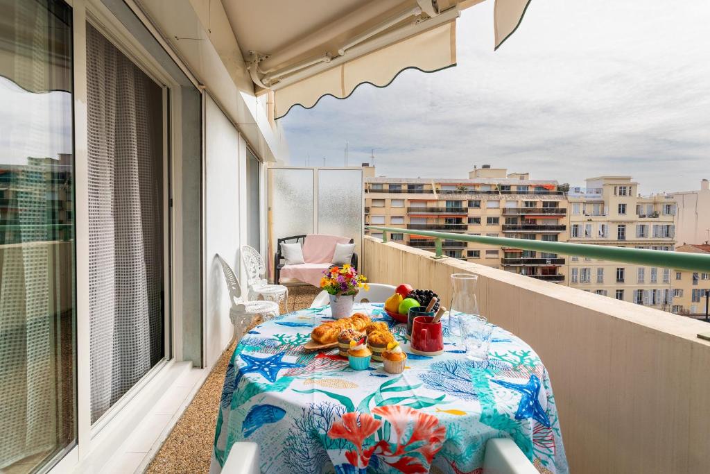 a table on a balcony with a view of a city at PALAIS DES ARTS AP4399 By Riviera holiday homes in Nice