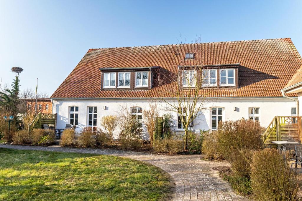 a white house with a red roof at Seeadler 11 in Buchholz