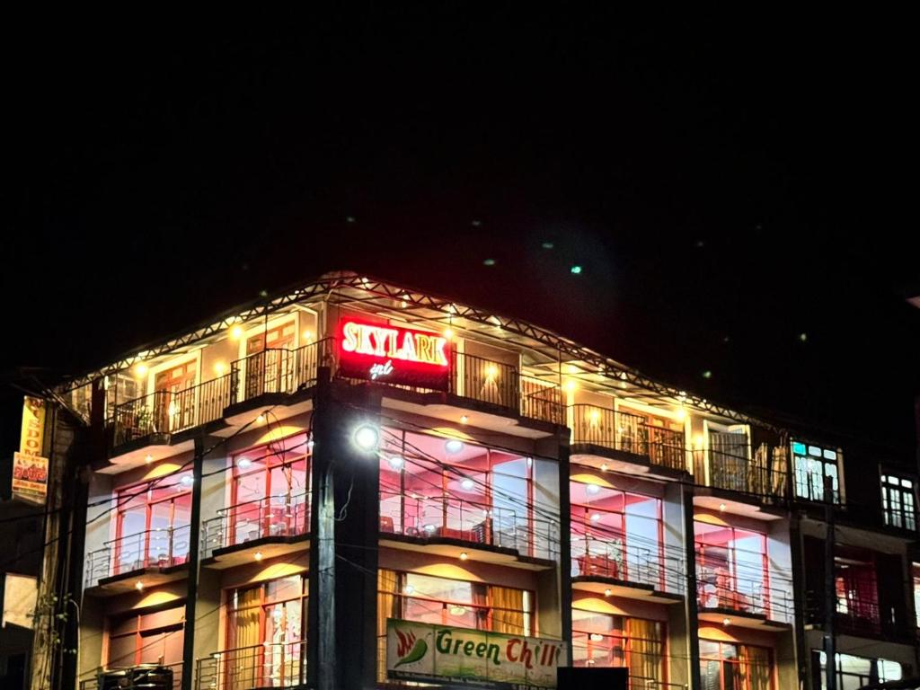 a lit up building with a sign on it at SkyLark Guest House in Nawalapitiya