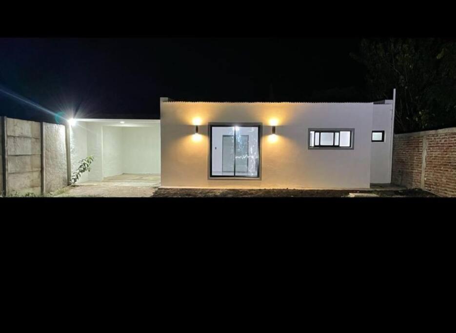 a house with lights on the side of it at night at Casa amplia y bien ubicada in Artigas