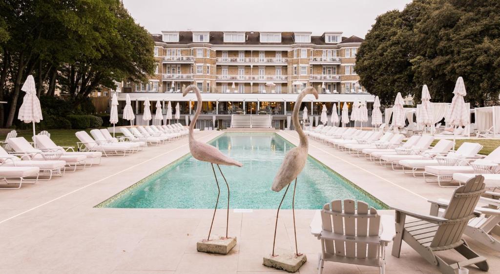 two pelicans statues in front of a swimming pool at The Nici in Bournemouth