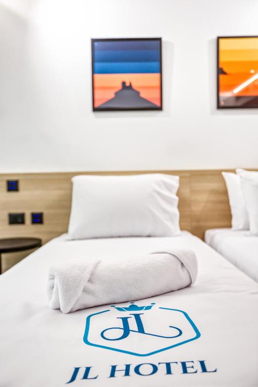 Postel nebo postele na pokoji v ubytování JL Hotel