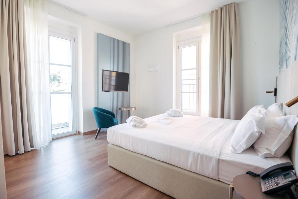 Postel nebo postele na pokoji v ubytování Hotel Arilica