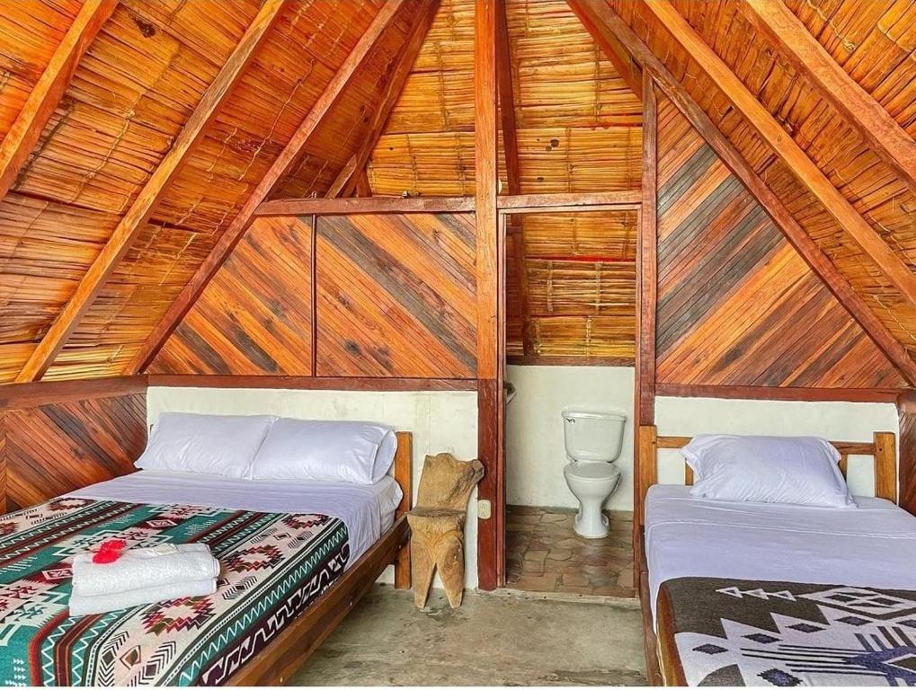 Postel nebo postele na pokoji v ubytování Hotel Palma Coco