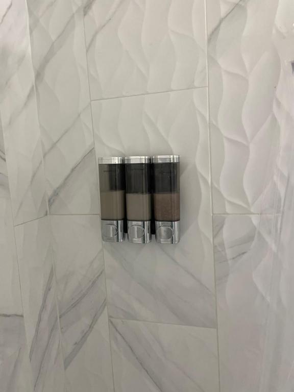 a bathroom with white marble walls and a soap dispenser at Ocean Springs Cottage 2 Bedroom 2 Bath in Ocean Springs