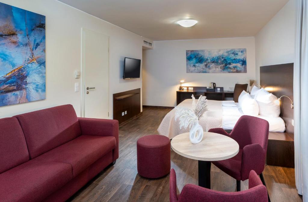 a living room with a couch and a table at Best Western Hotel am Spittelmarkt in Berlin