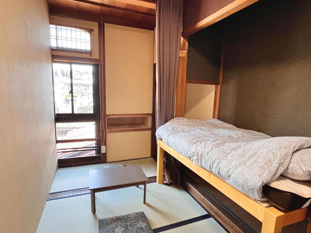 Postel nebo postele na pokoji v ubytování Hostel Miyagawa by Murasaki