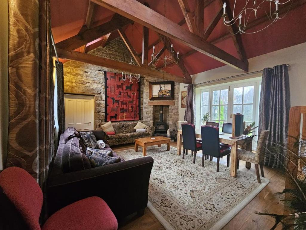 a living room with a couch and a table at Lakewood Courtyard Northumberland in Healey