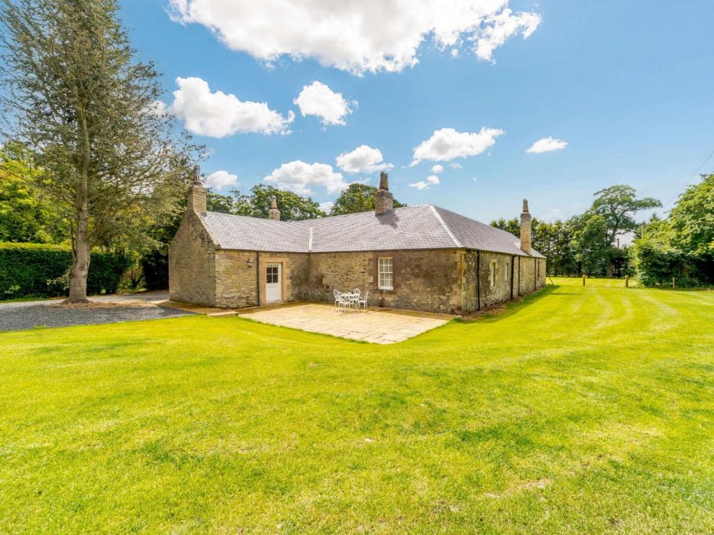 an old stone house on a large grass field at 2 bed property in Kelso 86452 in Birgham