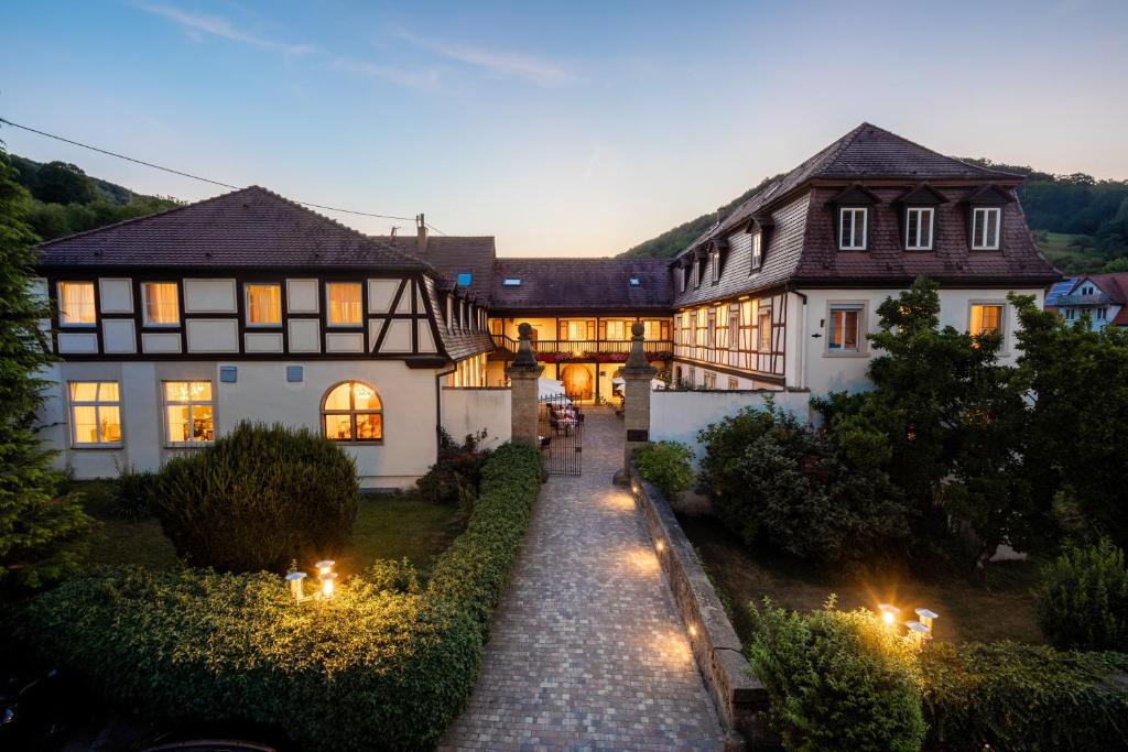 une grande maison avec un chemin en face de celle-ci dans l'établissement Schloss Döttingen, à Braunsbach