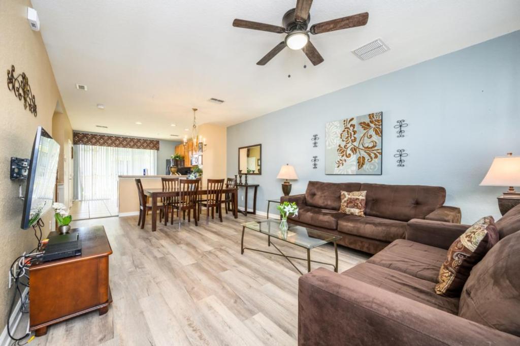 a living room with a couch and a ceiling fan at Beautiful Townhome, Vista Cay Resort Direct - 4010 in Orlando
