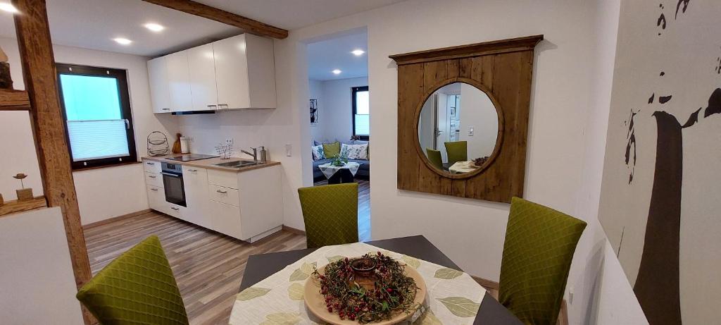 a kitchen and dining room with a table and a mirror at Gemütliche 3 1/2 Zimmer Wohnung in Ludwigsburg