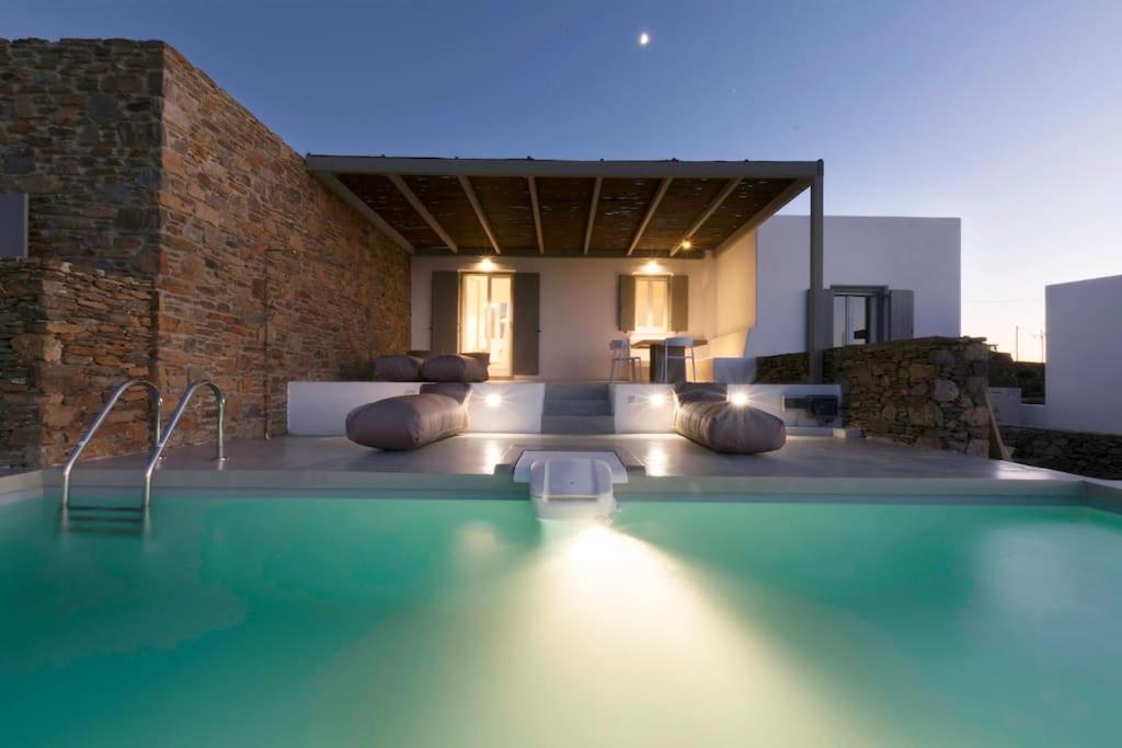 a swimming pool with pillows in a house at Villa with private pool in Dhriopís