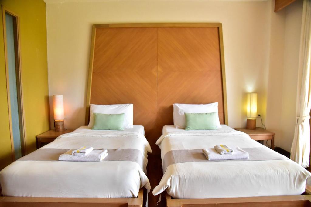 Postel nebo postele na pokoji v ubytování Tanaosri Resort Pranburi