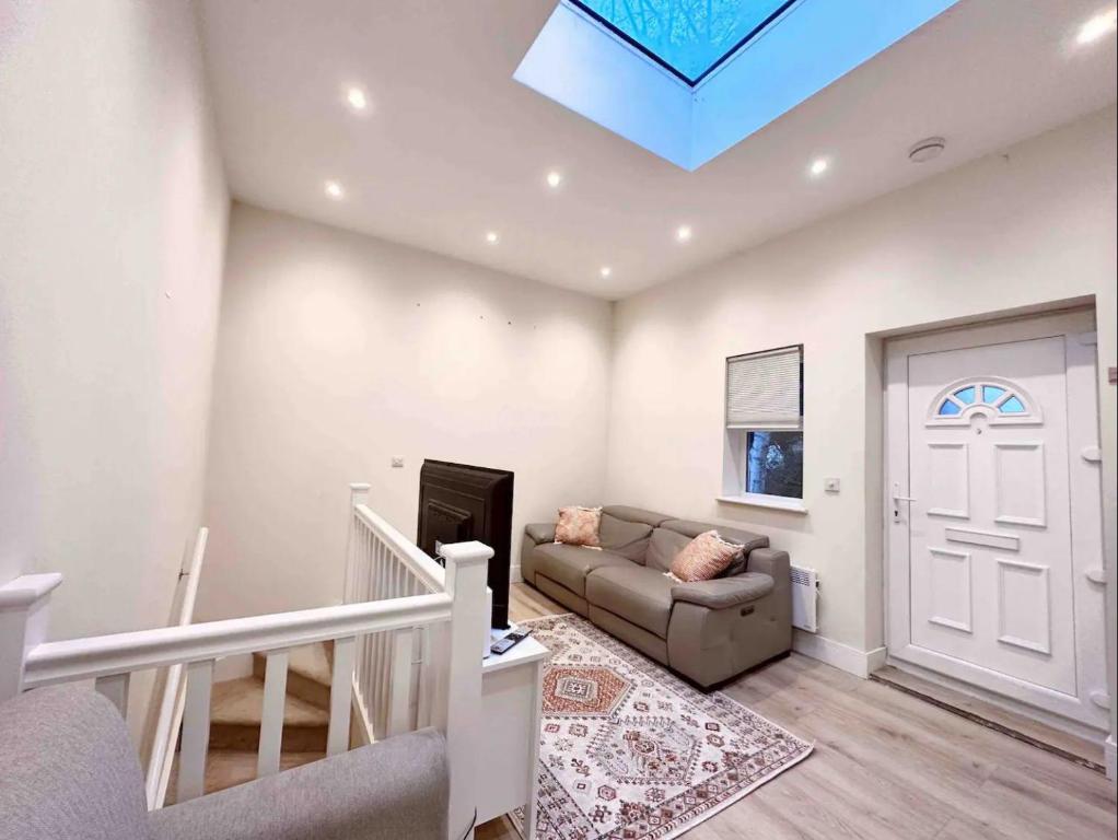 a living room with a couch and a skylight at Charming Duplex 10min to London Bridge Quiet in London