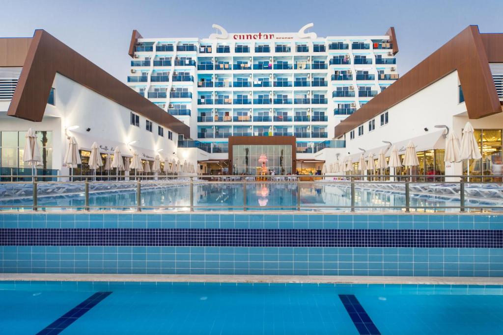 a swimming pool in front of a hotel at Sun Star Resort Hotel in Alanya