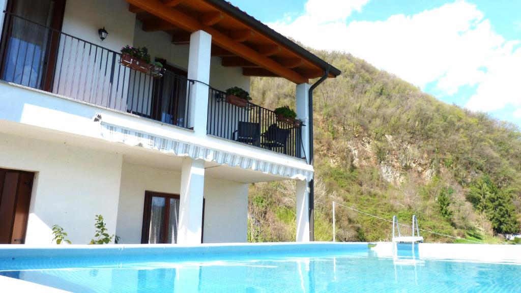 a hotel with a swimming pool in front of a mountain at Casa Modigliani - Tra Arte e Natura 
