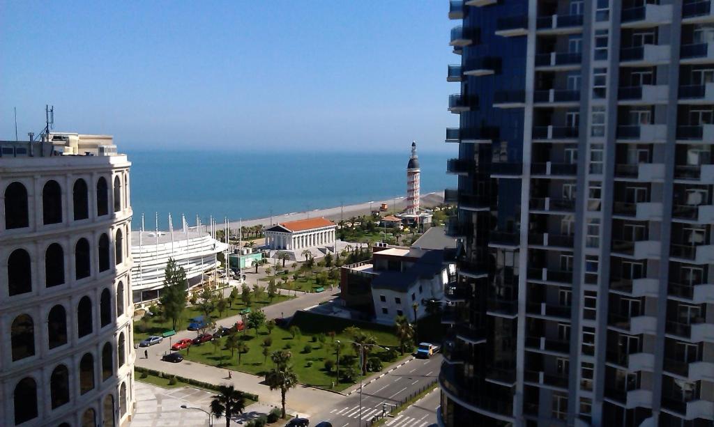 a view of a city with the ocean in the background at Orbi Sea Towers Batumi on Khimshiashvili 15 in Batumi